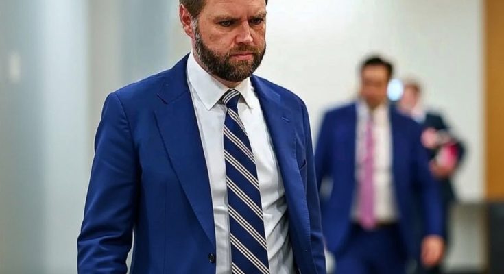Serious bearded man in blue suit walking hallway