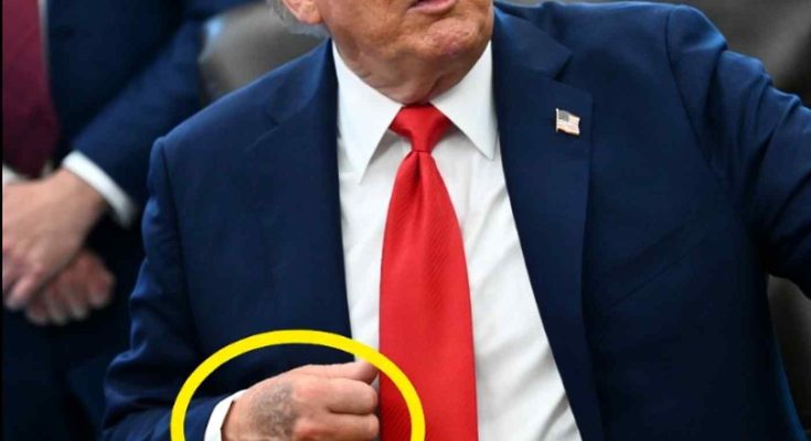 man in suit with tattooed hand during press event