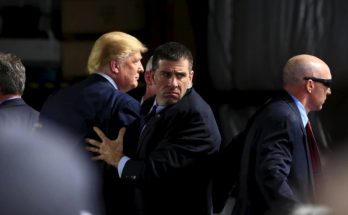 security team escorts public figure at crowded event