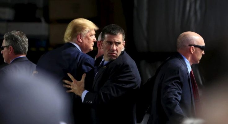 security team escorts public figure at crowded event