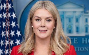 karoline Leavitt speaking at White House press briefing podium with American flag and