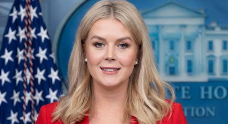 karoline Leavitt speaking at White House press briefing podium with American flag and